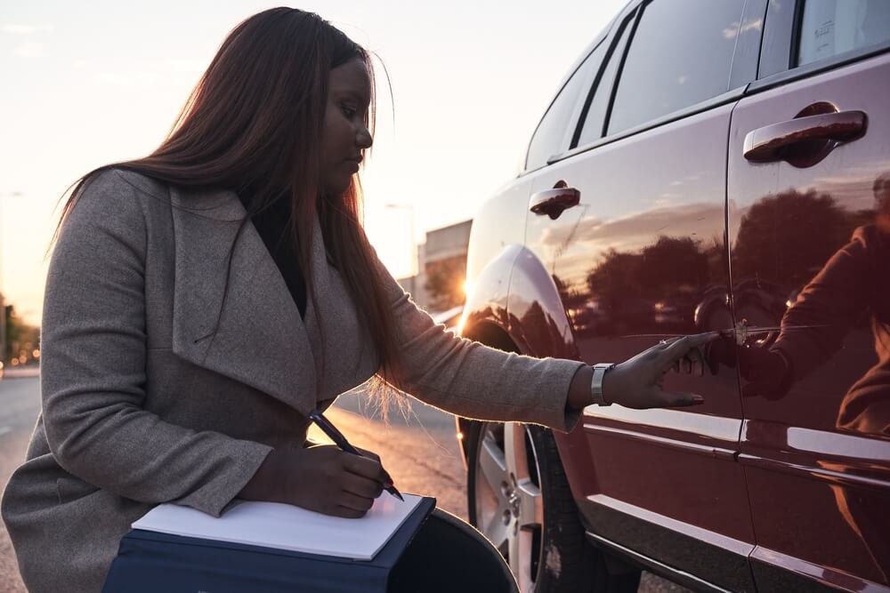 Title Loan representative inspecting vehicle