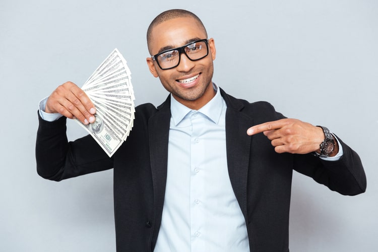 man holding car title loan cash